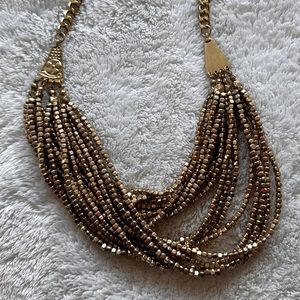 Layered gold beaded bib style necklace